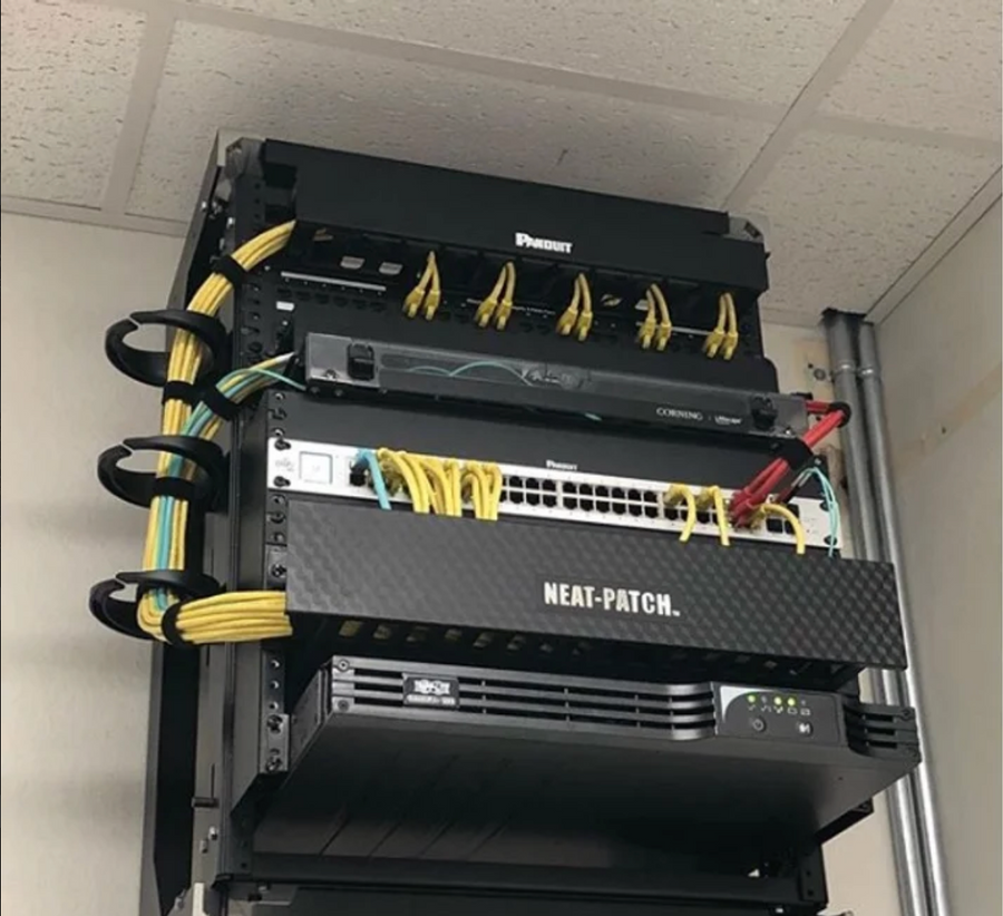 NEAT-PATCH cable management system keeping patch cords organized in compact wall-mounted network rack