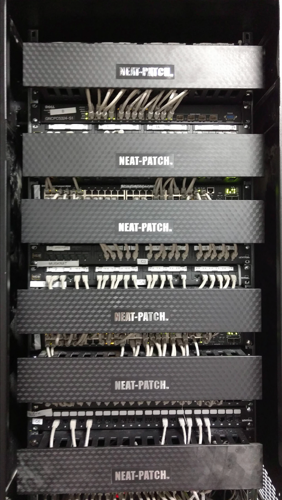 Structured cabling rack optimized with NEAT-PATCH cable managers, improving airflow and serviceability in network infrastructure