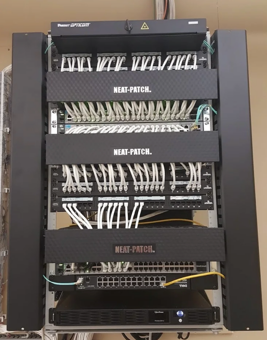 Enterprise network rack organized with NEAT-PATCH cable management, delivering uniform routing and clean patch panel alignment