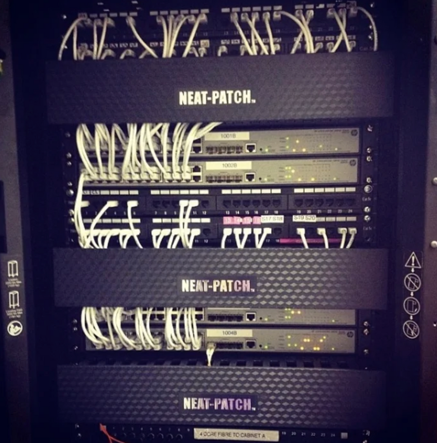 Enterprise network rack using NEAT-PATCH cable managers for clean cable routing and improved airflow control