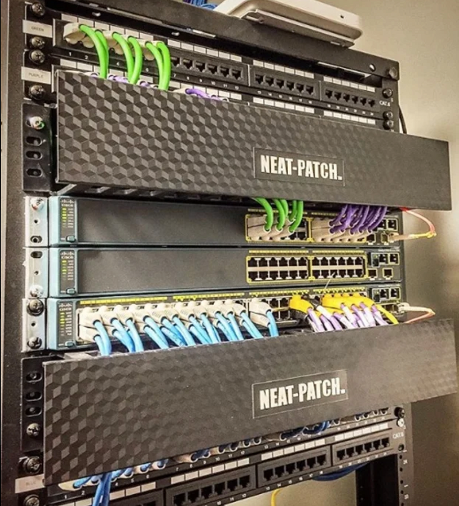 Structured network rack featuring NEAT-PATCH cable managers with color-coded patch cords and clean horizontal routing