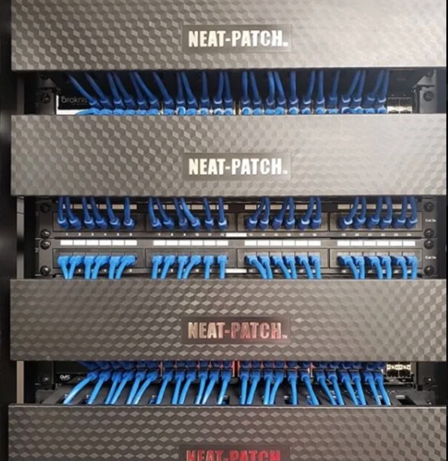 Structured cabling rack with aligned blue patch cords and layered horizontal cable managers for clean port access