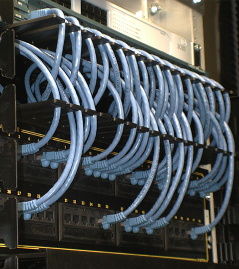 Structured cabling rack with uniform blue patch cable routing using NEAT-PATCH cable management system